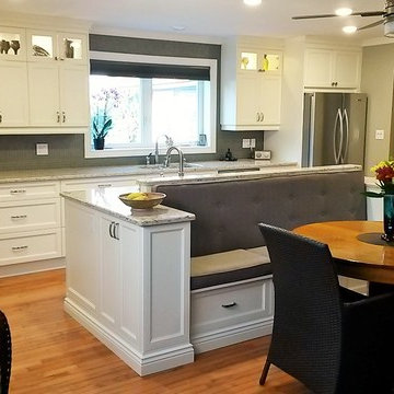 A custom white contemporary kitchen with bench seating