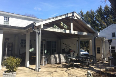 Inspiration for a medium sized classic back veranda in Other with natural stone paving and a roof extension.