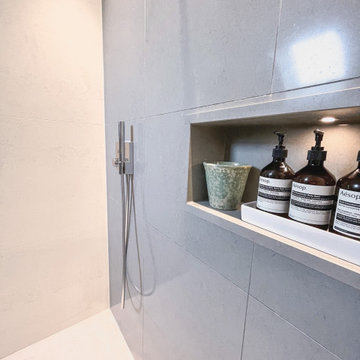 Walk in shower with recessed shelf for shower products