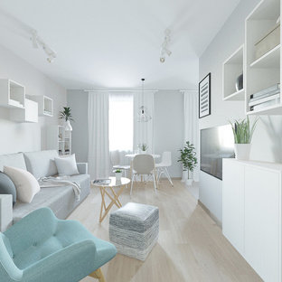 This is an example of a small scandi open plan living room in Other with grey walls, laminate floors, a wall mounted tv and pink floors.