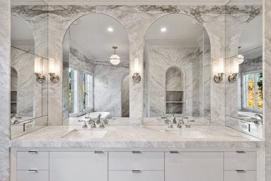 Mid-sized transitional master white tile and marble tile double-sink freestanding bathtub photo in San Francisco with white cabinets, white walls, a drop-in sink, marble countertops and white countertops