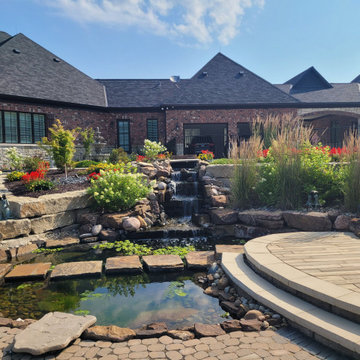 Estate Poolside Landscape & Hardscape Retreat with Custom Waterfeature