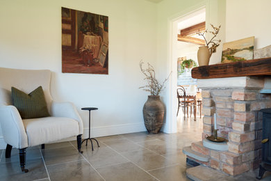 This is an example of a living room in Other with limestone flooring and grey floors.