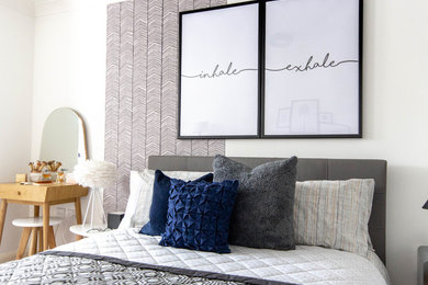This is an example of a large scandi master bedroom in Berkshire with white walls, carpet and brown floors.