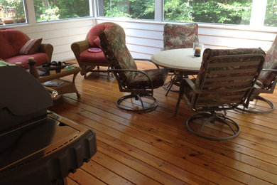 Design ideas for a large traditional sunroom in Raleigh with medium hardwood floors and brown floor.