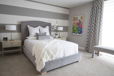Example of a mid-sized trendy guest carpeted bedroom design in San Diego with gray walls and no fireplace