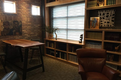 Mid-sized elegant carpeted and brown floor home office library photo in Other with brown walls
