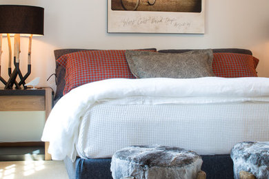 Example of a mountain style master carpeted bedroom design in Other with white walls