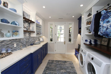 Large contemporary galley utility room in Orange County with an undermount sink, recessed-panel cabinets, blue cabinets, quartzite benchtops, beige walls, porcelain floors, a side-by-side washer and dryer, beige floor and white benchtop.
