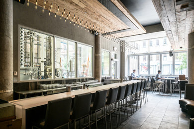 Inspiration for a large industrial black floor kitchen/dining room combo remodel in Chicago with gray walls