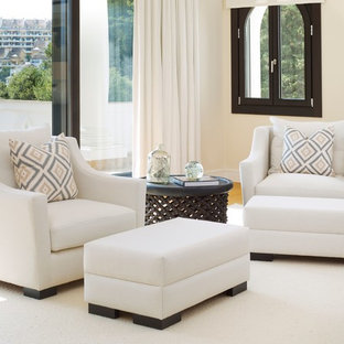 Design ideas for an expansive contemporary master bedroom in Malaga with beige walls, medium hardwood floors, brown floor and a wood stove.