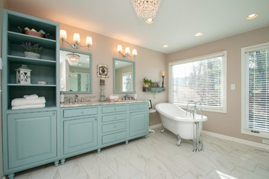 Bathroom - large modern master gray tile and porcelain tile porcelain tile and gray floor bathroom idea in Other with recessed-panel cabinets, blue cabinets, a two-piece toilet, blue walls, granite countertops, a hinged shower door, gray countertops and an undermount sink