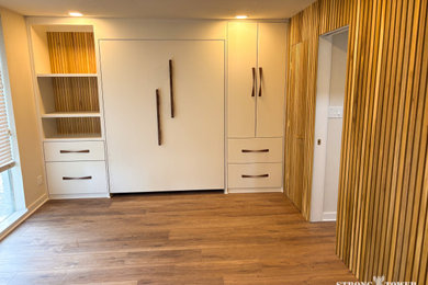 Bedroom - large contemporary master light wood floor and brown floor bedroom idea in Houston with beige walls