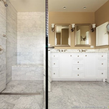 White marble curbless shower with custom shower bench