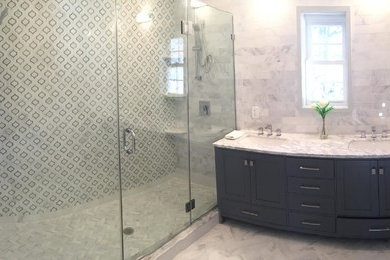 Mid-sized contemporary master bathroom in New York with recessed-panel cabinets, blue cabinets, an alcove shower, multi-coloured tile, an undermount sink, quartzite benchtops and a hinged shower door.