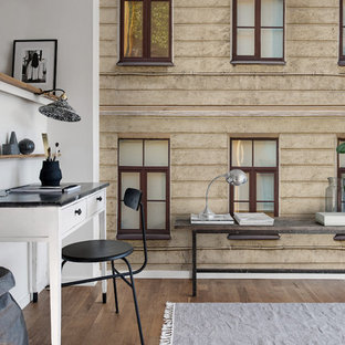 Inspiration for a modern home office and library in Gothenburg with yellow walls.