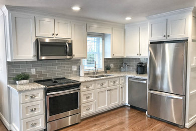 Example of a mid-sized classic single-wall eat-in kitchen design in Tampa with shaker cabinets and no island