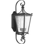 Progress Lighting - Cadence Collection Black 1-Light Small Wall Lantern - This wall lantern has a decorative and fashion-orientated design with modern classic styling. The clear water seeded glass shade gives off a soft glow of light. The beautiful black-finished lantern frame gently holds the shade in place.