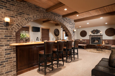 Example of a large classic ceramic tile and beige floor home bar design in Miami