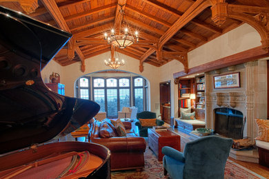 This is an example of a large traditional enclosed living room in San Francisco with beige walls, medium hardwood floors, a standard fireplace, a stone fireplace surround, a music area and no tv.