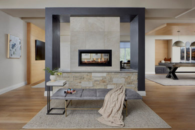 Inspiration for a contemporary vinyl floor and wood ceiling living room remodel in Denver with a two-sided fireplace and a stone fireplace