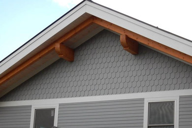 Inspiration for a blue three-story stone gable roof remodel in Boston