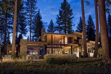 Photo of an expansive contemporary two-storey brown exterior in Sacramento with stone veneer and a flat roof.