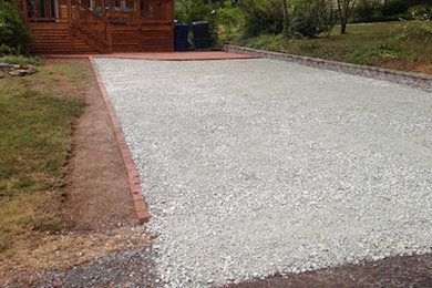 Inspiration for a mid-sized traditional full sun front yard stone driveway in Raleigh for fall.