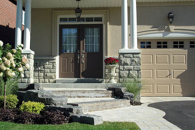 This is an example of a mid-sized transitional full sun front yard concrete paver garden path in Toronto.