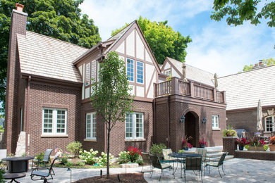 Elegant brown three-story brick exterior home photo in Chicago