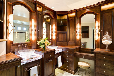 Inspiration for a mid-sized timeless master white tile and porcelain tile porcelain tile bathroom remodel in Phoenix with a vessel sink, recessed-panel cabinets, beige cabinets, wood countertops, a one-piece toilet and multicolored walls