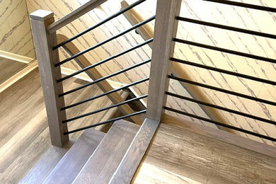 Mid-sized trendy wooden u-shaped mixed material railing staircase photo in New York with wooden risers