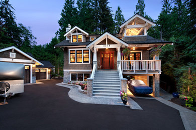 Large arts and crafts two-storey brown house exterior in Vancouver with wood siding, a gable roof and a shingle roof.