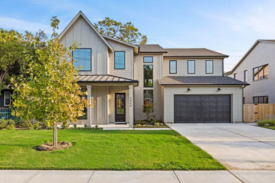 Example of a large cottage beige two-story mixed siding and board and batten exterior home design in Dallas with a mixed material roof and a brown roof