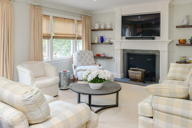 Example of a mid-sized transitional enclosed carpeted family room design in New York with gray walls, a standard fireplace, a wall-mounted tv and a wood fireplace surround