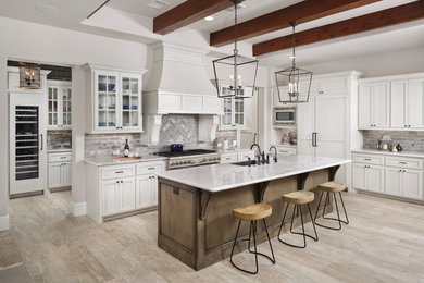 Design ideas for a mid-sized country l-shaped eat-in kitchen in Houston with a farmhouse sink, recessed-panel cabinets, grey cabinets, granite benchtops, grey splashback, brick splashback, stainless steel appliances, porcelain floors, with island, grey floor and grey benchtop.