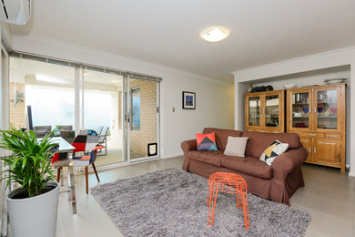 Design ideas for a mid-sized eclectic open concept living room in Perth with white walls, ceramic floors and no fireplace.