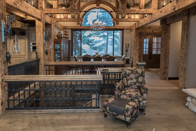 Inspiration for a mid-sized rustic open concept light wood floor and brown floor living room remodel in Denver with brown walls