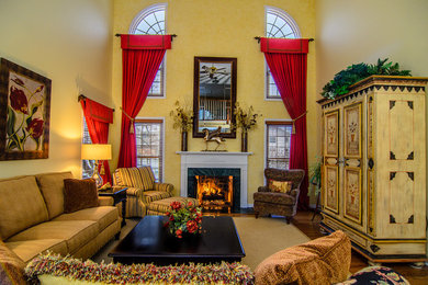 Living room - large traditional formal and open concept medium tone wood floor living room idea in Chicago with yellow walls, a standard fireplace and a concealed tv