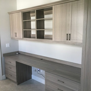 Photo of a medium sized modern home office and library in Other with white walls, ceramic flooring, a built-in desk and grey floors.