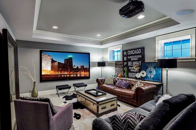 This is an example of a mid-sized eclectic enclosed home theatre in Chicago with grey walls, carpet, a projector screen and grey floor.