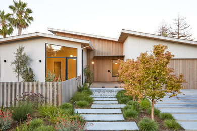 Inspiration for a large modern beige one-story mixed siding exterior home remodel in San Francisco with a shingle roof