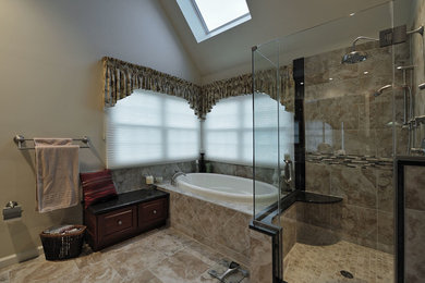 Inspiration for a large timeless master beige tile and porcelain tile porcelain tile bathroom remodel in Philadelphia with an undermount sink, raised-panel cabinets, dark wood cabinets, granite countertops, a two-piece toilet and beige walls