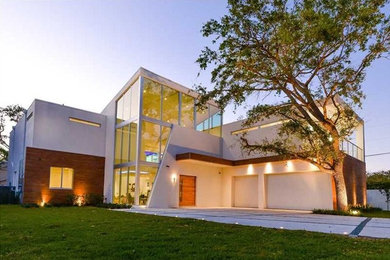 Inspiration for a large modern white two-story stucco exterior home remodel in Miami