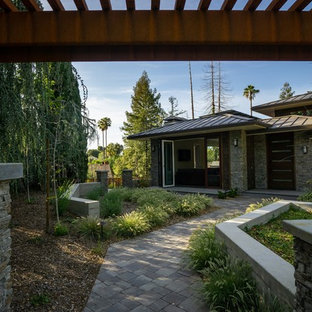 This is an example of an arts and crafts front yard shaded xeriscape in San Francisco with with path and natural stone pavers.