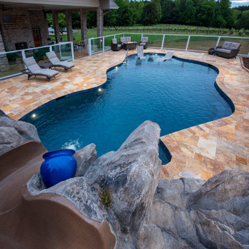 Vineyard view pool with custom slide and boulder work