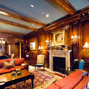 Diseño de sótano con puerta de estilo americano, grande, con paredes marrones, suelo de piedra caliza, chimenea tradicional y marco de chimenea de piedra