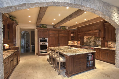 Large elegant l-shaped eat-in kitchen photo in New York with an undermount sink, beaded inset cabinets, dark wood cabinets, granite countertops, stone slab backsplash, stainless steel appliances and an island
