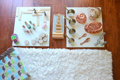 Mid-sized trendy girl dark wood floor nursery photo in San Francisco with gray walls