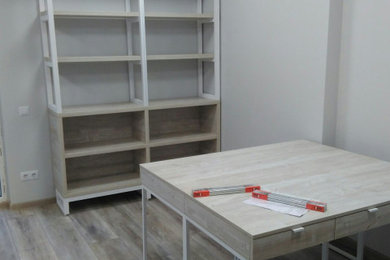 Mid-sized danish laminate floor and brown floor home office photo in Other with gray walls